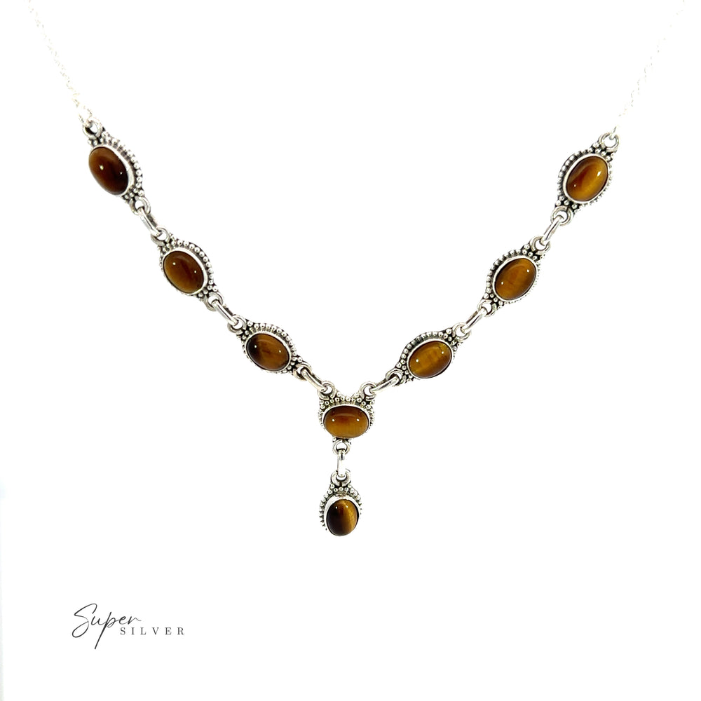 
                  
                    A Gemstone Y-Necklace with Beaded Border with tiger eye and turquoise stones on it. Each gemstone is carefully selected for its vibrant color and natural beauty.
                  
                