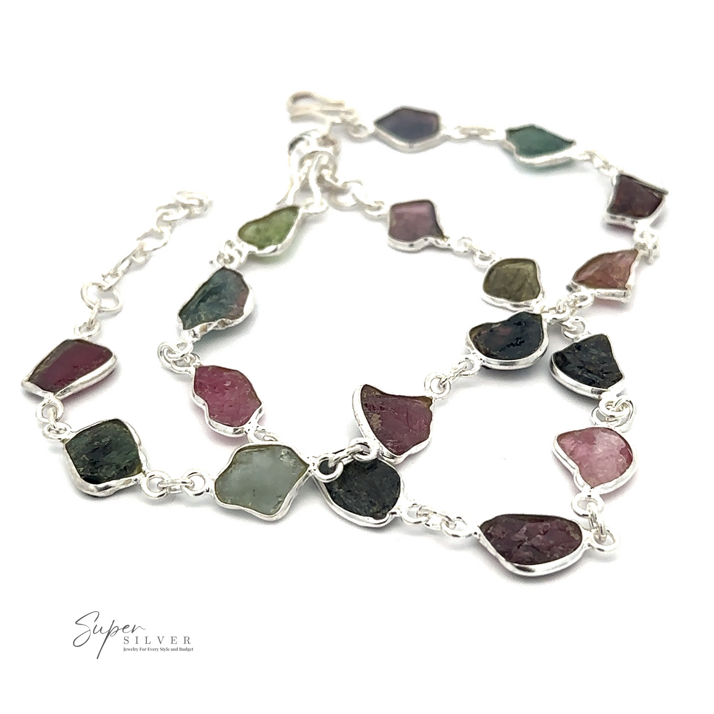
                  
                    A Rough Tourmaline Bracelet featuring irregularly shaped, multicolored rough tourmaline stones, arranged in a linked chain design. The product exudes earthy elegance and is branded with "Super Silver" in the lower left corner.
                  
                