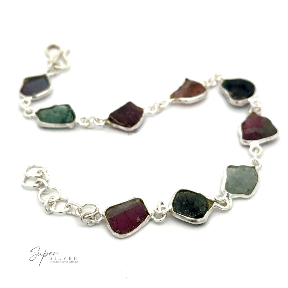 
                  
                    A Rough Tourmaline Bracelet displaying multiple irregularly shaped rough tourmaline stones, connected by links, with a branded logo "Super Silver" in the corner.
                  
                