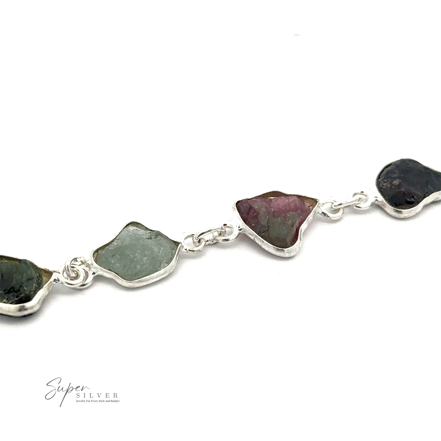 
                  
                    A Rough Tourmaline Bracelet featuring irregularly shaped, unpolished multicolored stones exudes earthy elegance. The rough tourmaline stones vary in color, including green, pink, and dark brown. This bracelet is from "Super Silver.
                  
                