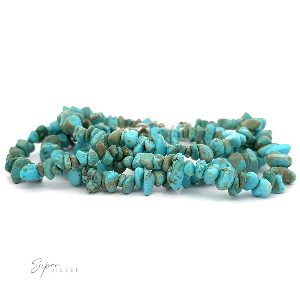 
                  
                    A Southwest Colorado Turquoise Chip Bracelet or Anklet made of multiple strands of irregularly shaped turquoise beads, radiating southwest charm, is displayed against a white background. The logo "Super Silver" is seen in the bottom left corner.
                  
                