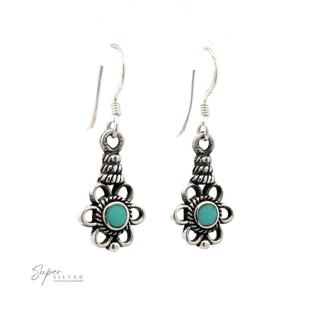 
                  
                    A pair of Flower Design Earrings With a Round Stone featuring intricate flower designs with turquoise stones in the center and hooks for wearing.
                  
                