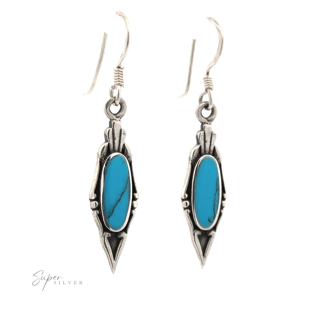 A pair of Elegant Inlaid Earrings with Oval Stone featuring elongated turquoise stones with black marbling, hanging from Sterling Silver hooks, exuding a vintage design.