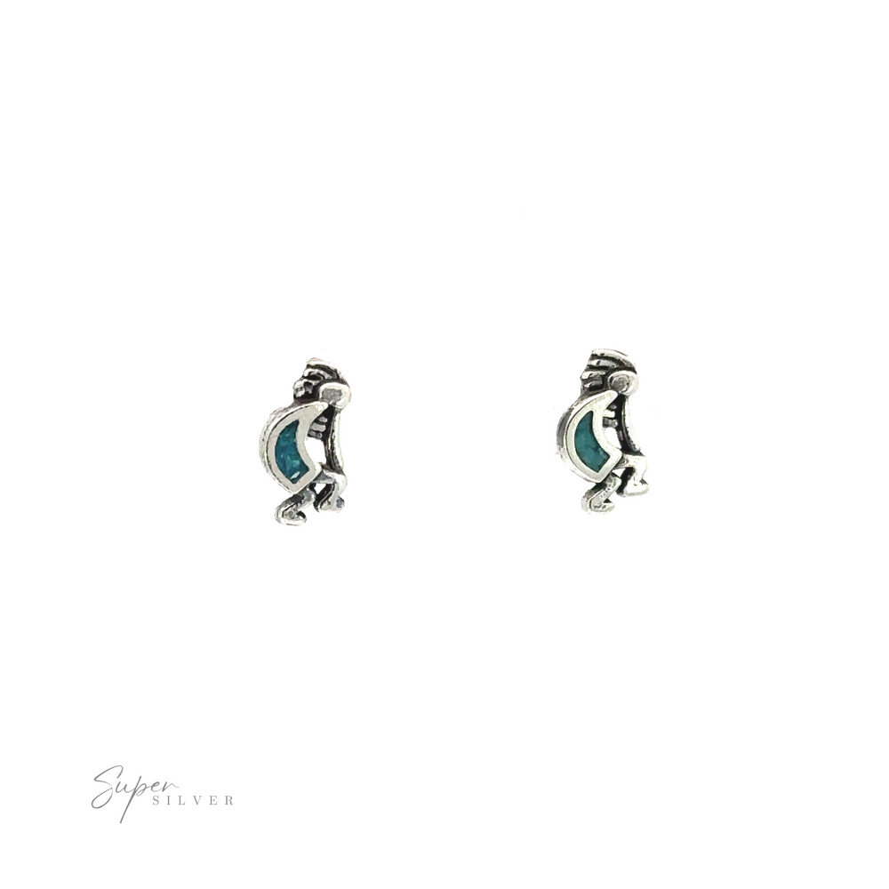 A pair of silver Turquoise Kokopelli stud earrings with reconstituted turquoise stones.