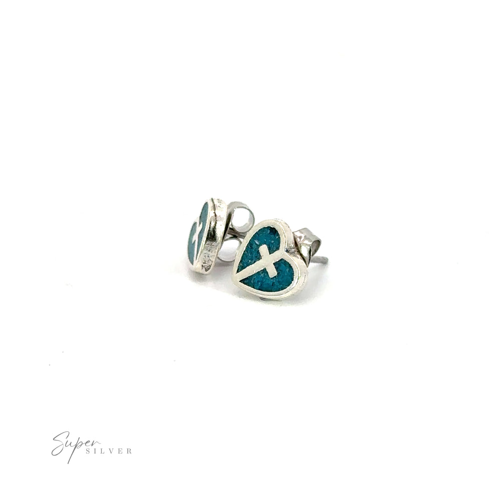 A pair of turquoise heart stud earrings with a silver cross emblem, perfect for showcasing your Christian faith through stylish jewelry.