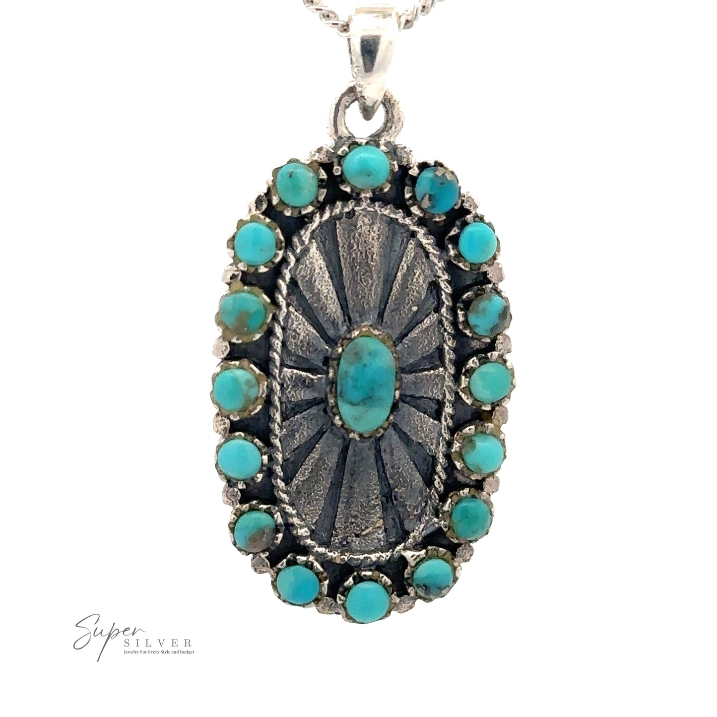 An oval turquoise and metal Native Inspired Turquoise Pendant with a sunburst pattern, surrounded by small turquoise stones, hangs from a silver chain. This Native-Inspired piece exudes Southwestern charm. The logo "Super Silver" is visible in the bottom left corner.