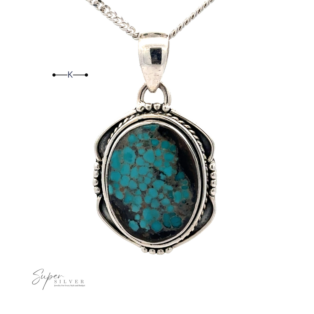 
                  
                    A Natural Turquoise Pendant with an Oval Shield Setting, intricately detailed with handmade silver work, is suspended from a fine silver chain.
                  
                