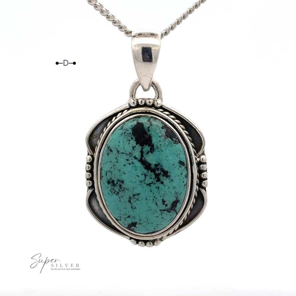 
                  
                    A Natural Turquoise Pendant with an Oval Shield Setting featuring an oval natural turquoise stone set in sterling silver, with detailed metalwork surrounding the stone and a chain attached at the top. "Super Silver" is marked at the bottom left corner.
                  
                