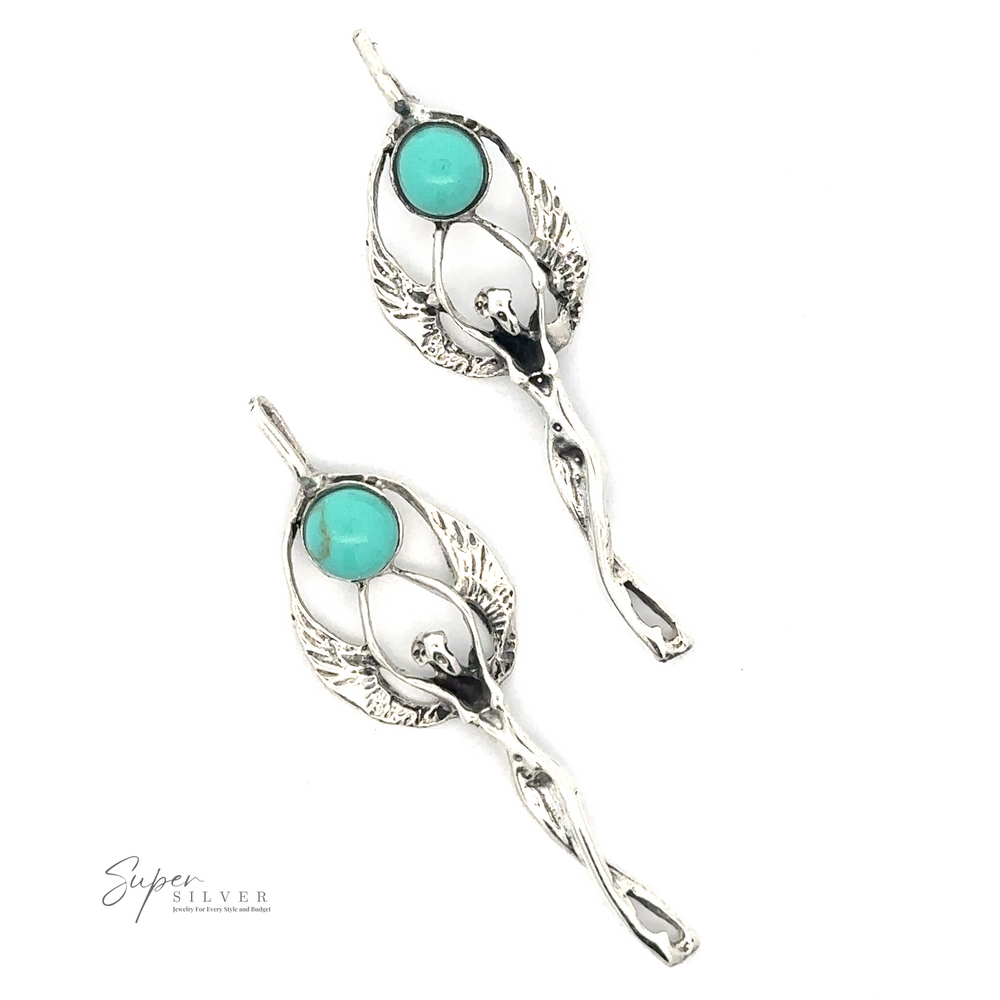 
                  
                    Two Fairy Angel Turquoise Pendants featuring an intricate design of elongated winged maidens holding circular turquoise stones.
                  
                