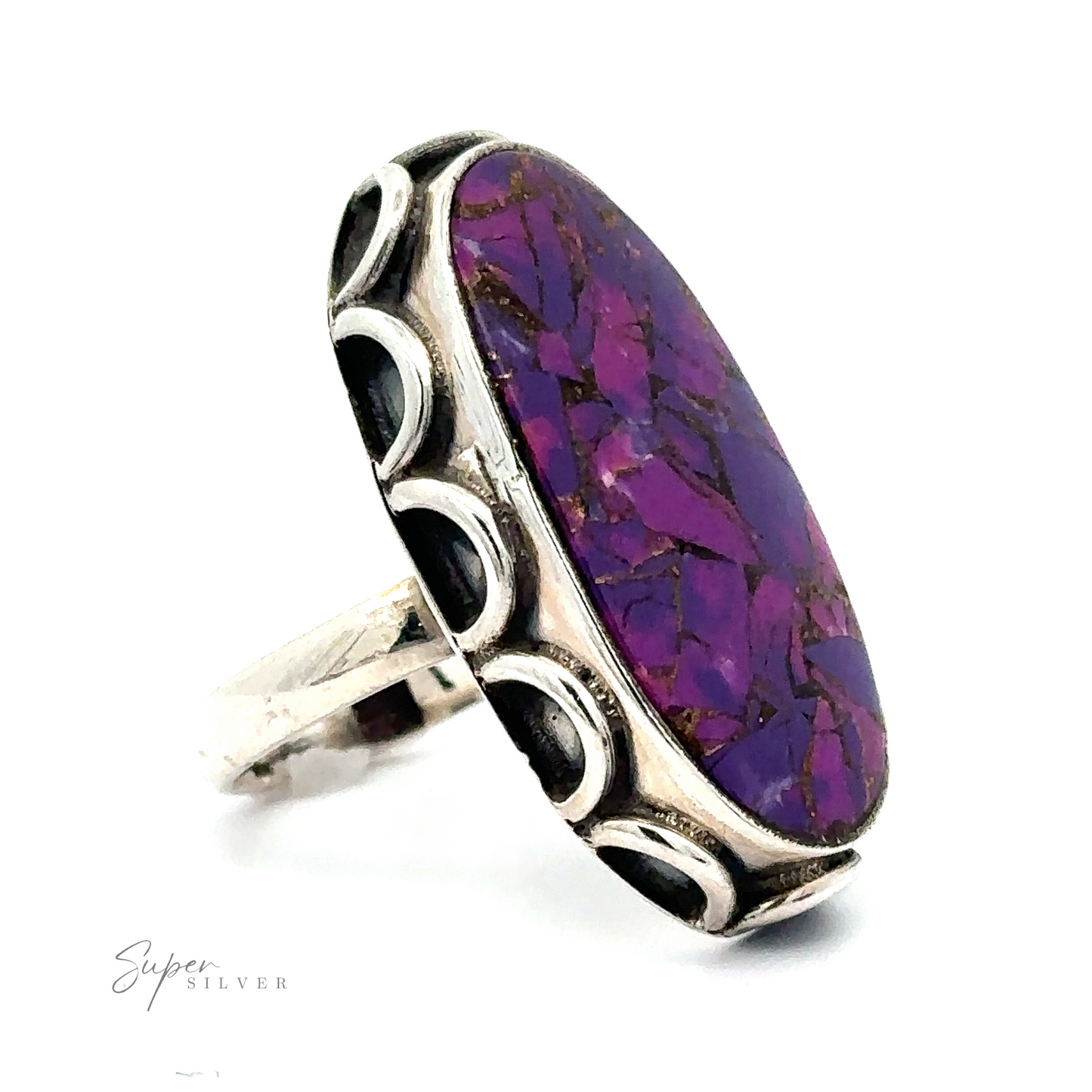 
                  
                    A Statement Purple Turquoise Ring featuring an oval-shaped purple stone with a mosaic pattern, set in a decorative silver band.
                  
                