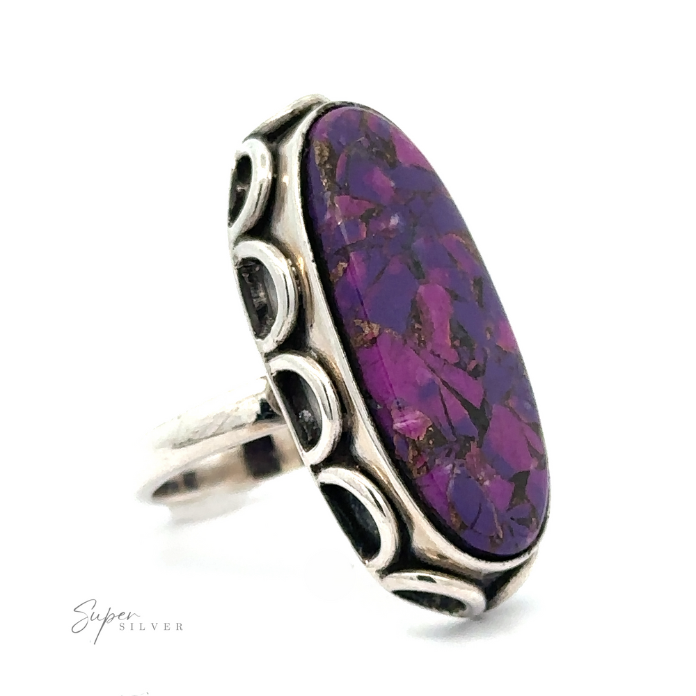 
                  
                    A silver ring featuring a large, oval-shaped Statement Purple Turquoise Ring stone with intricate silver detailing around the band. The text "Super Silver" appears in the corner.
                  
                