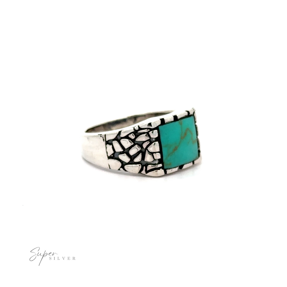 
                  
                    A silver stone signet ring with an inlaid turquoise stone.
                  
                