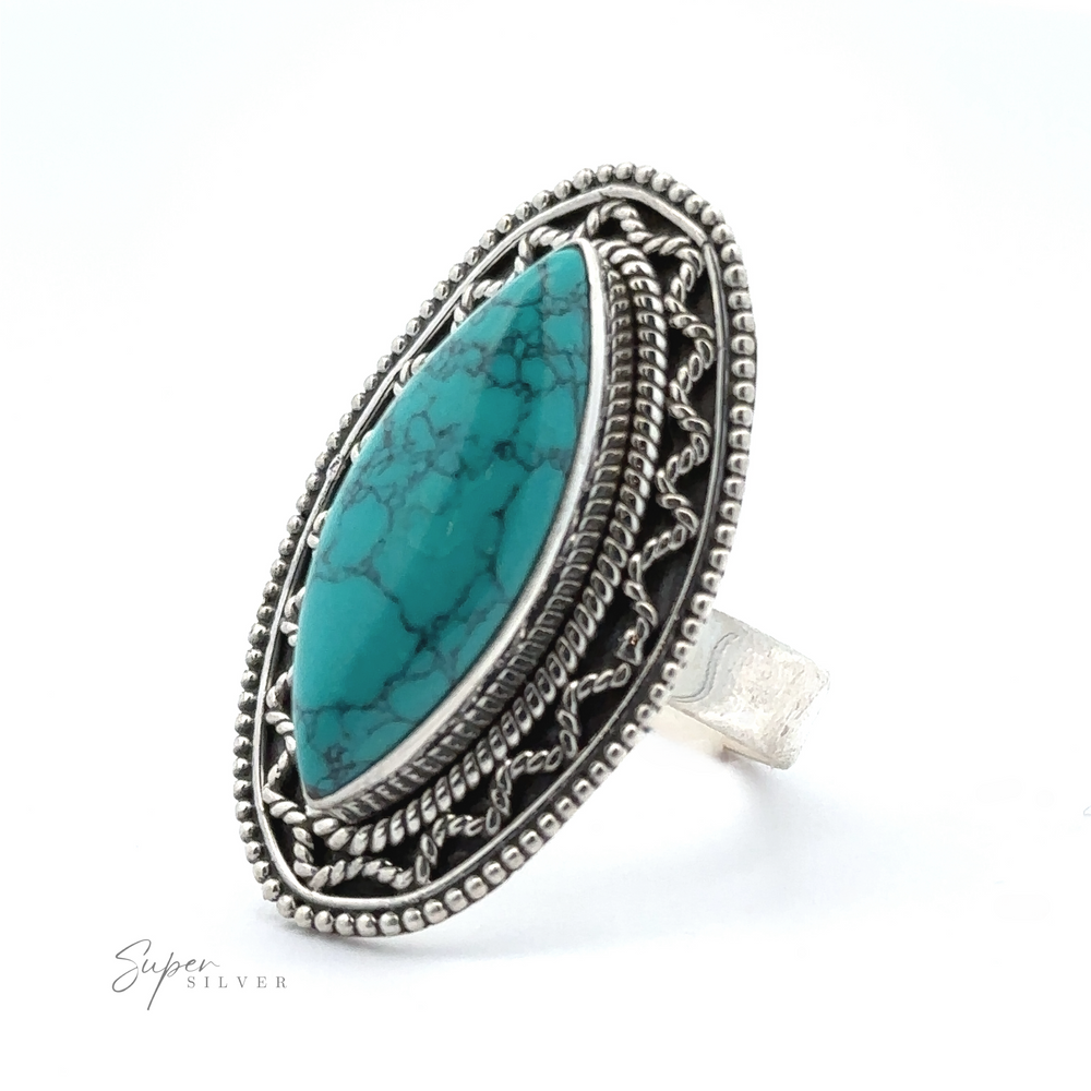 
                  
                    A silver ring featuring an oval turquoise stone set within an intricate, decorative border. With natural veining and a Bohemian twist, the Marquise Shaped Gemstone Ring With Vintage Shield Border is marked 'Super Silver.'
                  
                