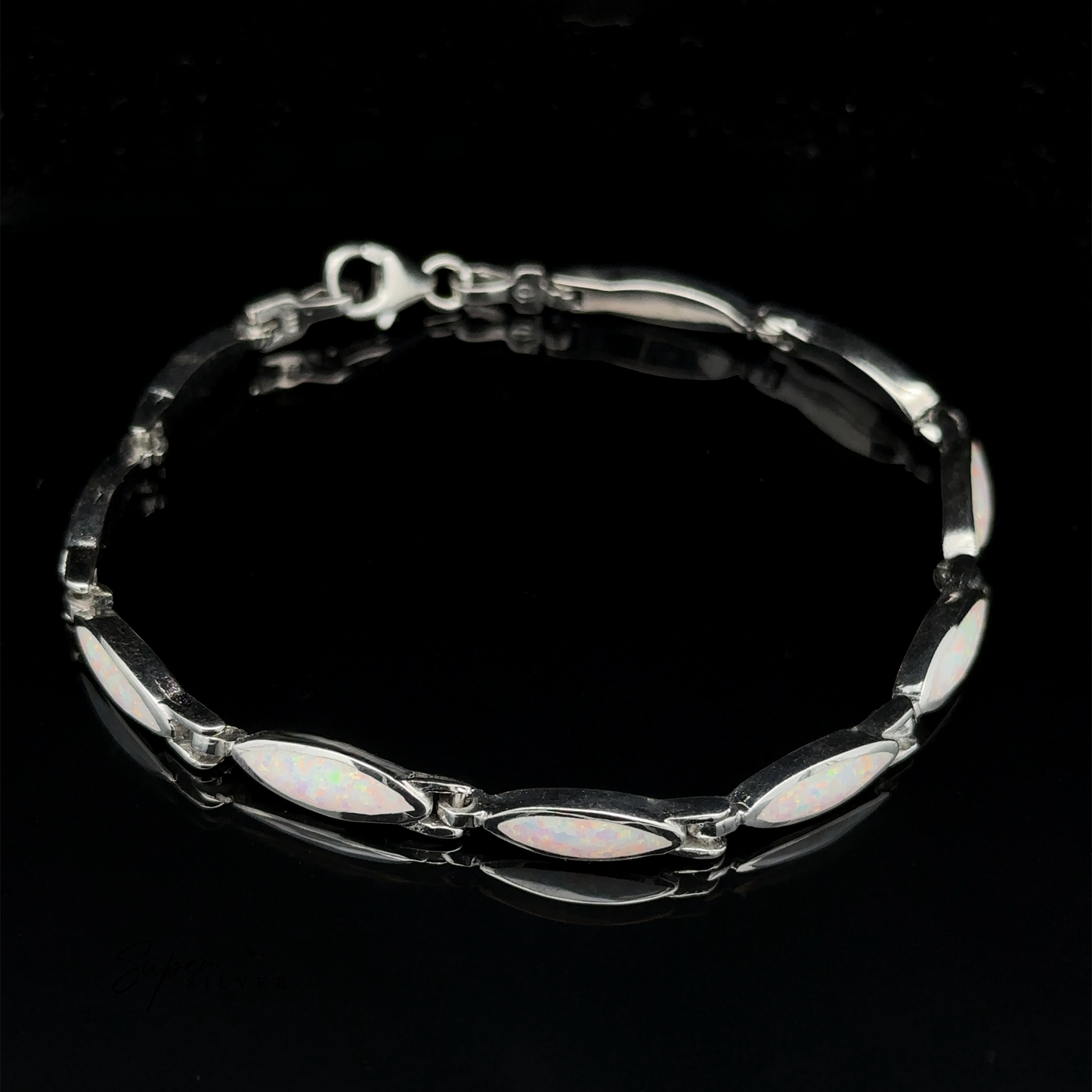 
                  
                    The Marquise Shaped Lab-Created Opal Bracelet features a modern design with marquise-shaped lab-created opal stones set in the links, arranged in a chain pattern against a black background.
                  
                