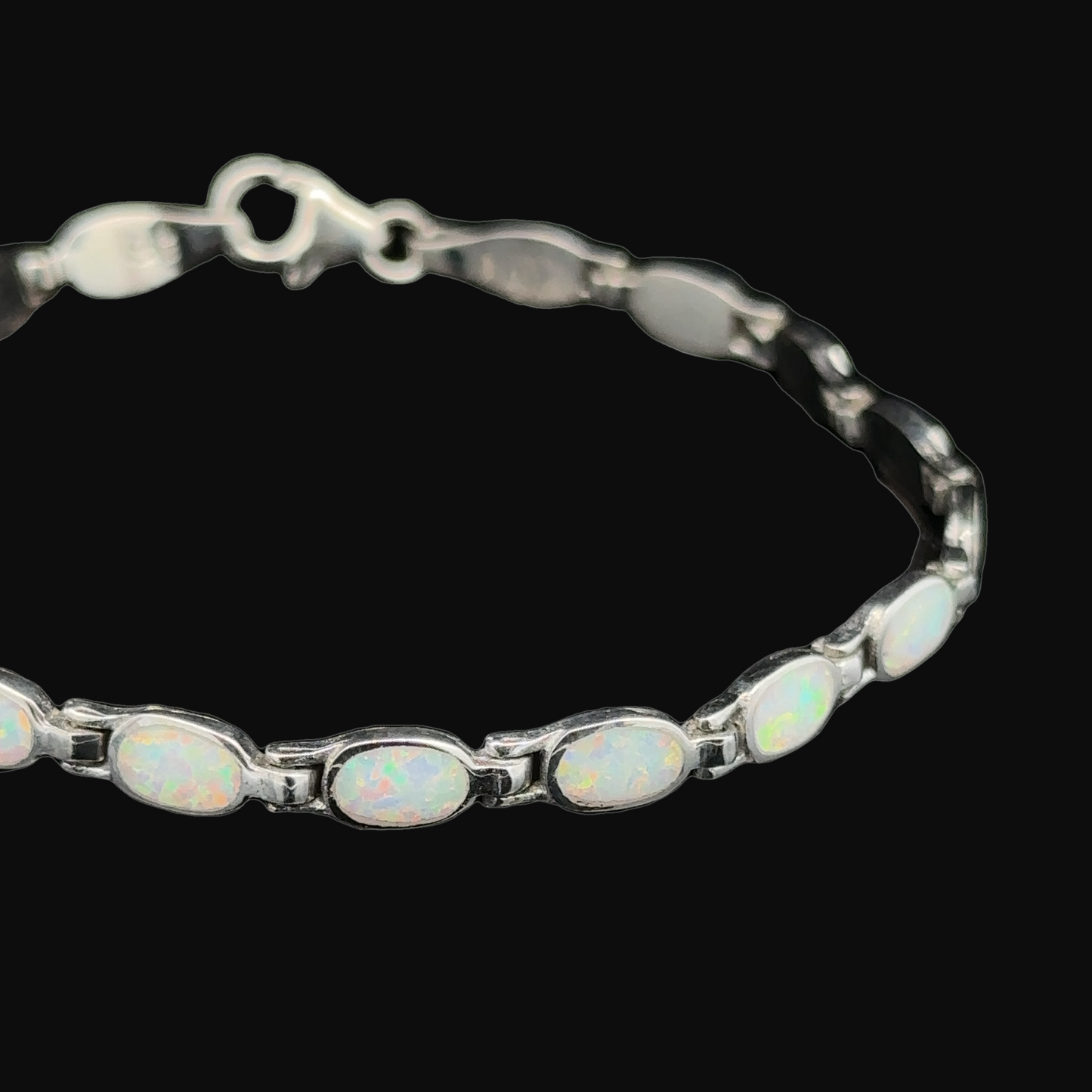 
                  
                    The Oval Lab-Created Opal Bracelet showcases modern elegance with a series of oval lab-created opal stones set in .925 Sterling Silver.
                  
                