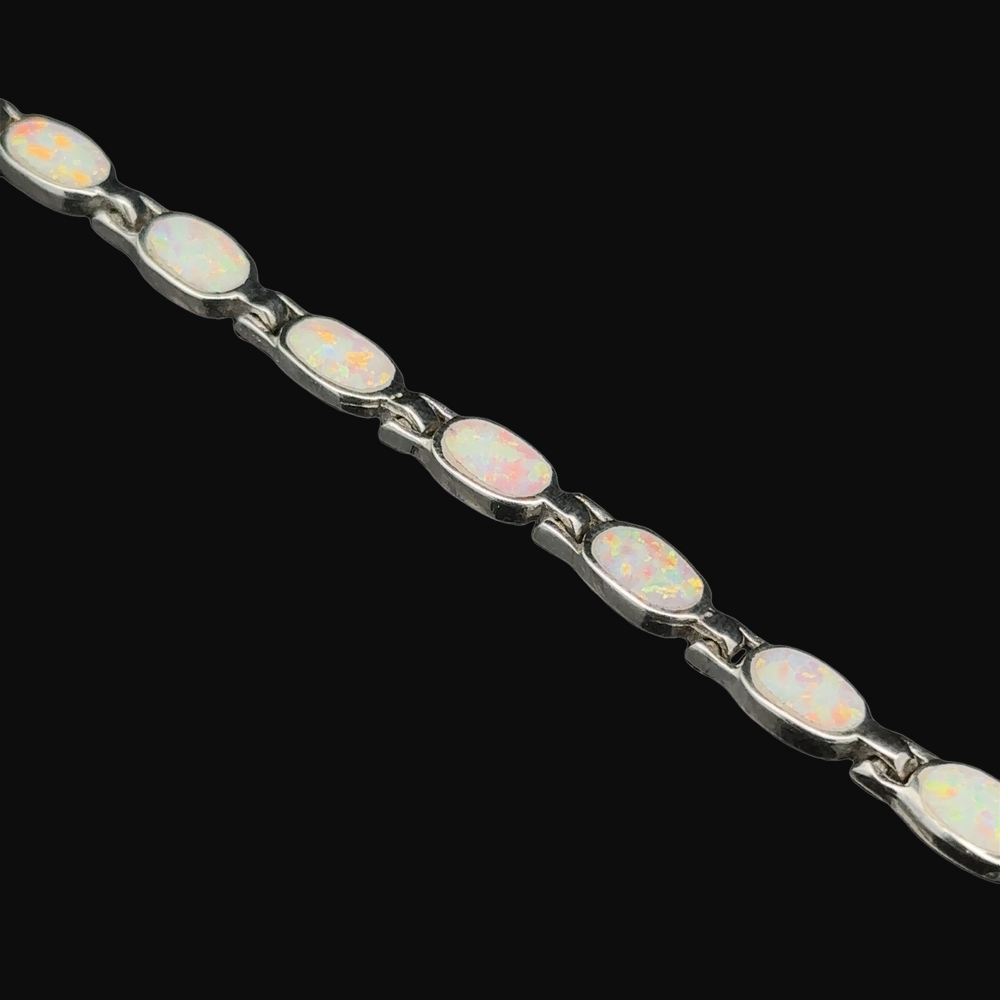 
                  
                    A modern and elegant "Oval Lab-Created Opal Bracelet" featuring white opal stones set in .925 Sterling Silver.
                  
                