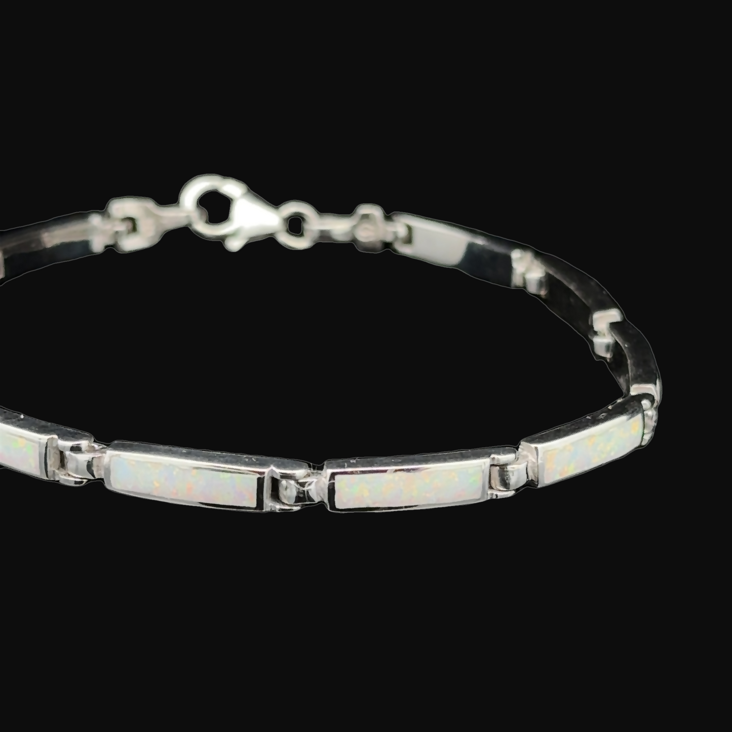 
                  
                    Experience the charm of the Long Rectangle Lab-Created Opal Bracelet, a sterling silver piece featuring rectangular opal inlays set against a striking black background.
                  
                