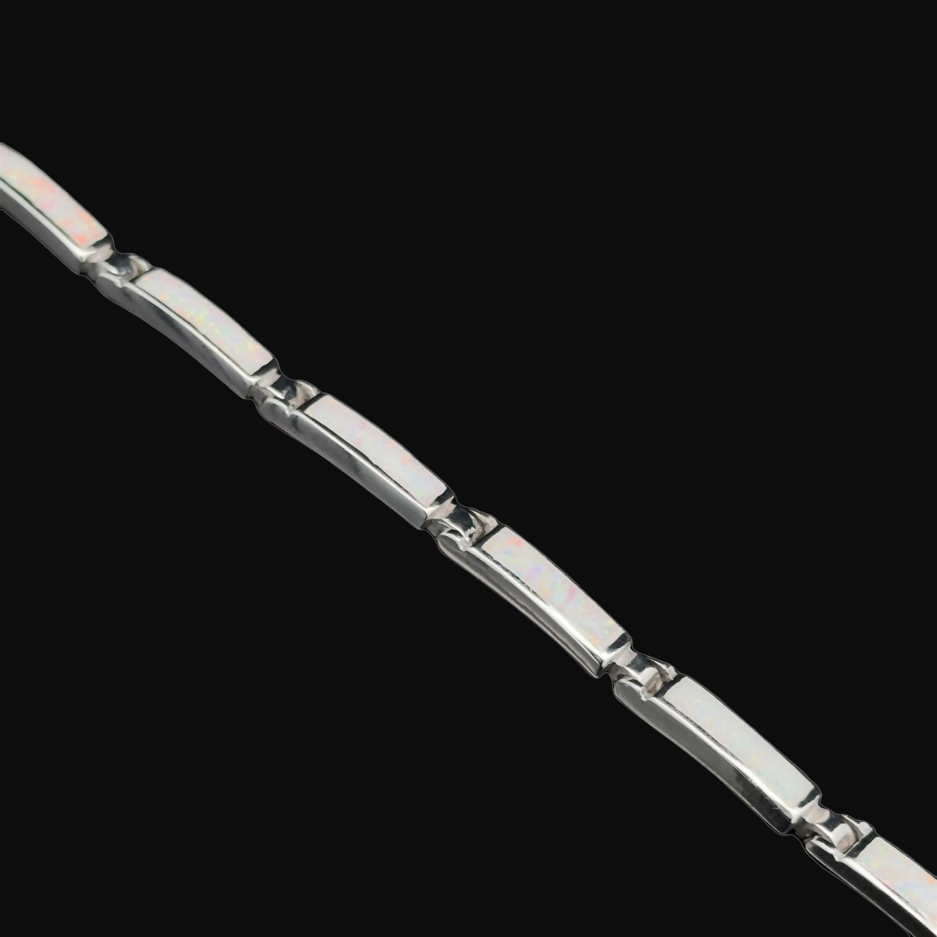 Long Rectangle Lab-Created Opal Bracelet featuring rectangular links and a radiant opal glow, set against a sleek black background.