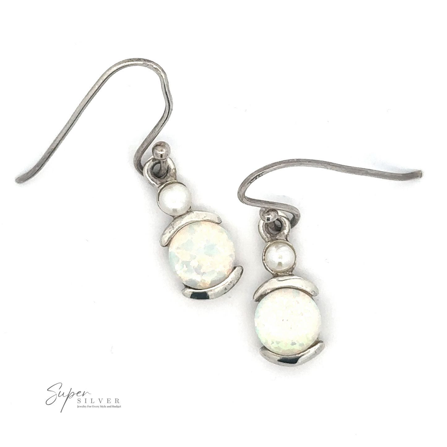 
                  
                    A pair of White Created Opal Oblong Earrings featuring a round lab-created opal gemstone and a small silver bead above it, with hook closures.
                  
                