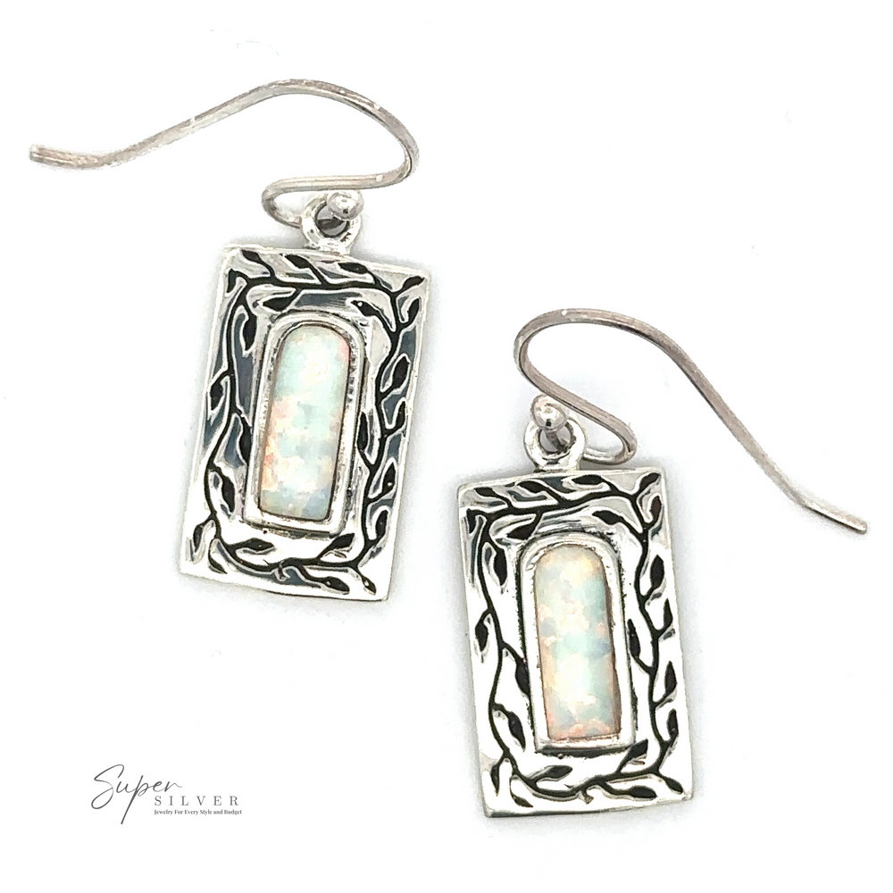 
                  
                    A pair of White Created Opal Square Earrings with intricate designs and iridescent lab-created opal stones, displayed on a white background. The Super Silver logo is visible in the bottom left corner.
                  
                