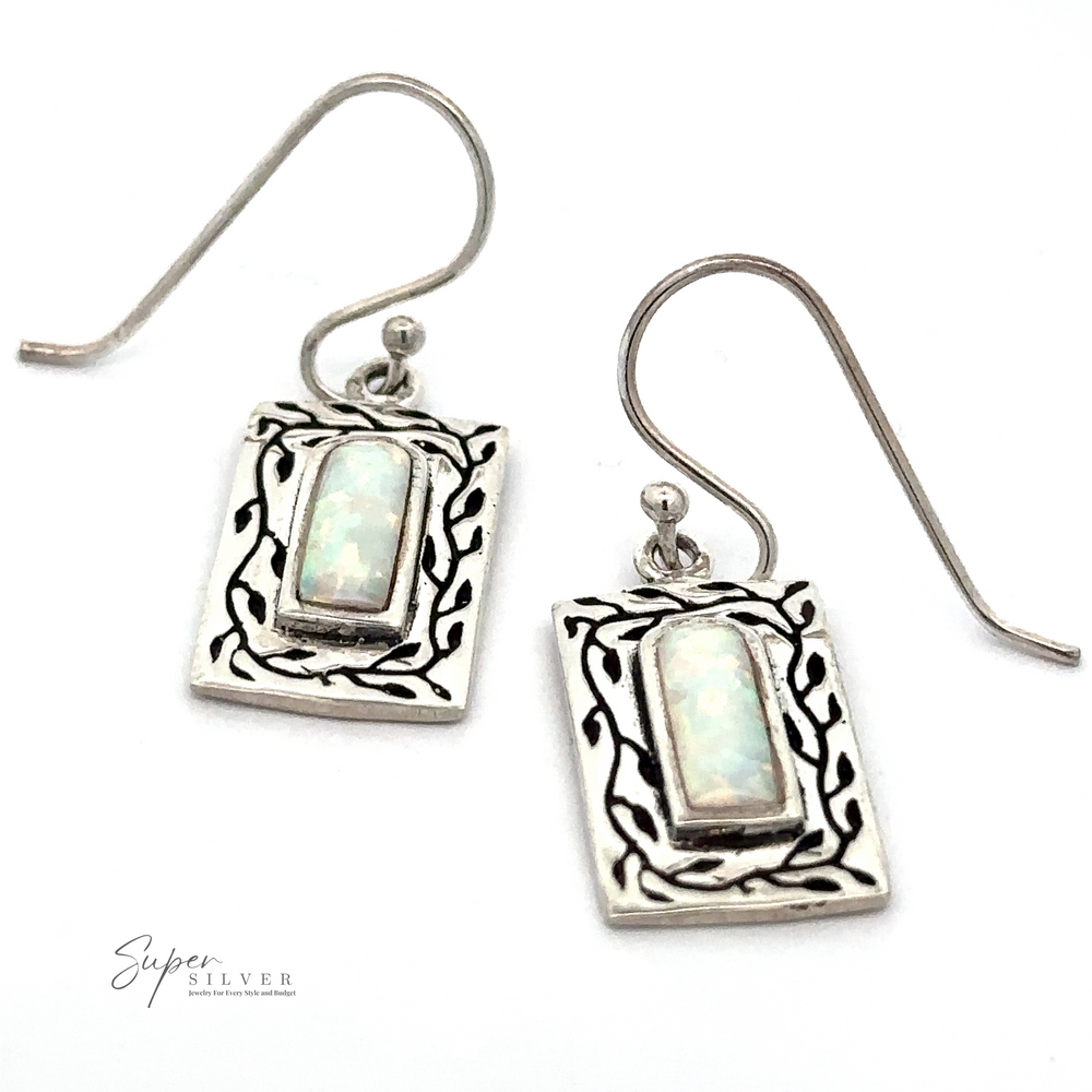 A pair of White Created Opal Square Earrings with intricate silver detailing and hook-style backs. The background is white, and the text 