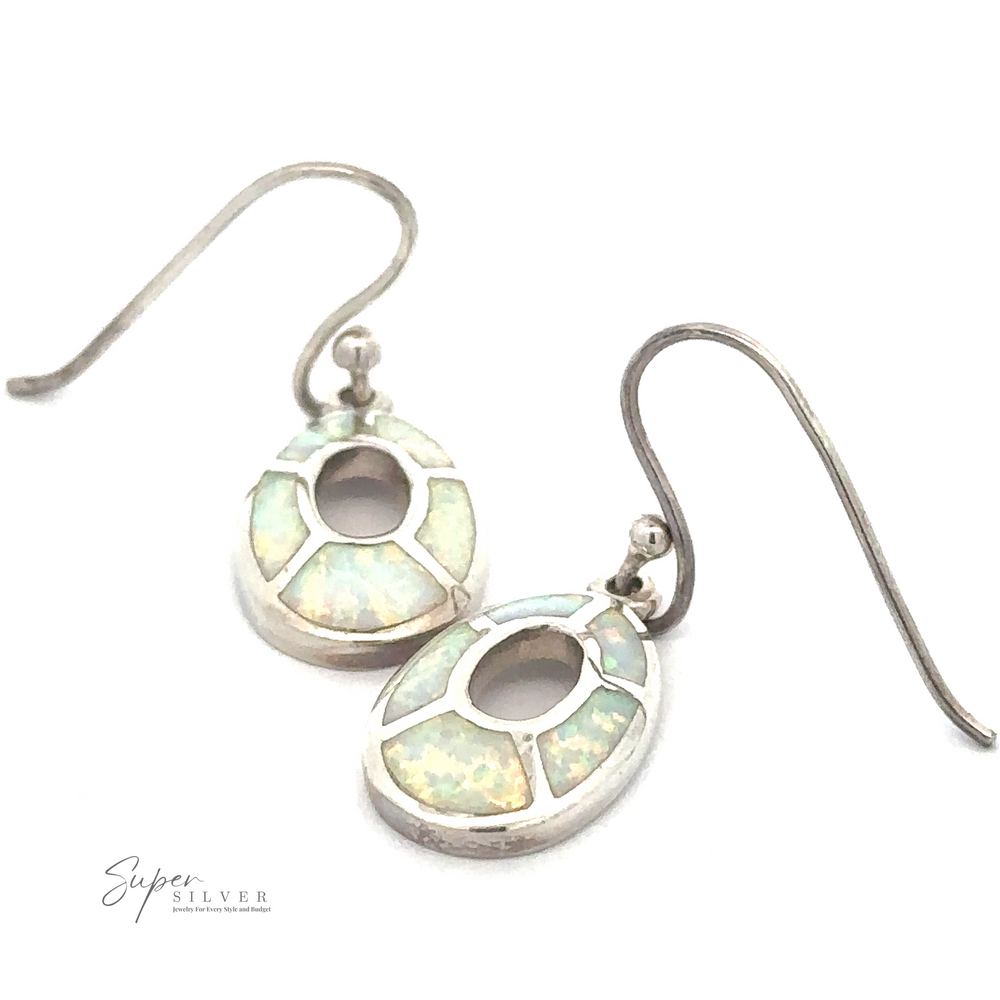 A pair of sterling silver earrings with an intricate design featuring light blue and white gemstone inlays, displayed on a white background. The brand name 