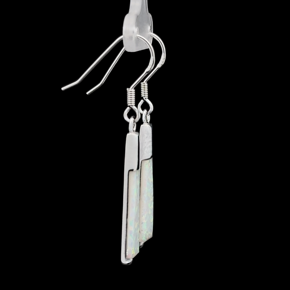 
                  
                    The Elegant Long Opal Earrings are a stunning pair of silver drop earrings featuring rectangular, translucent stones, perfect for the contemporary artsy woman seeking a touch of modern flair.
                  
                