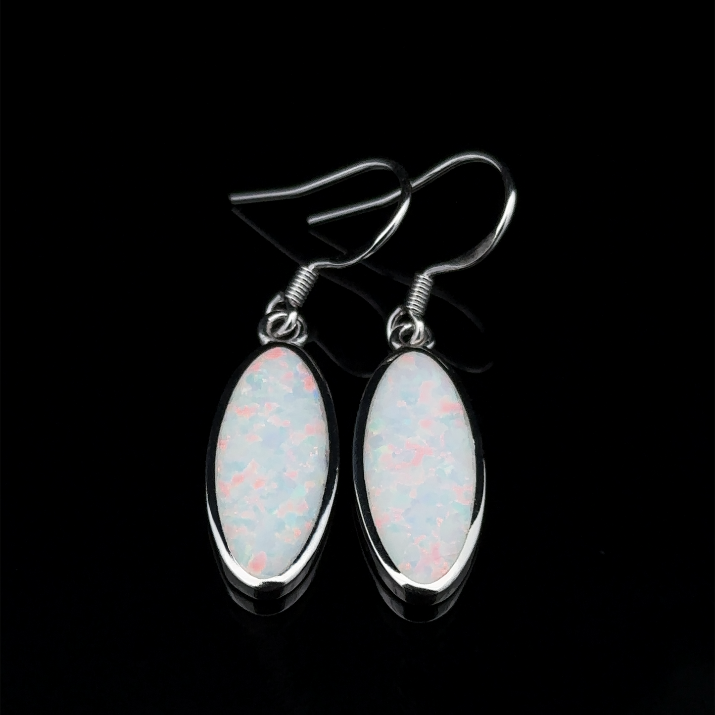 
                  
                    A pair of Simple Oval Lab-Created Opal Earrings featuring sterling silver and iridescent white lab-created opal stones on a black backdrop.
                  
                