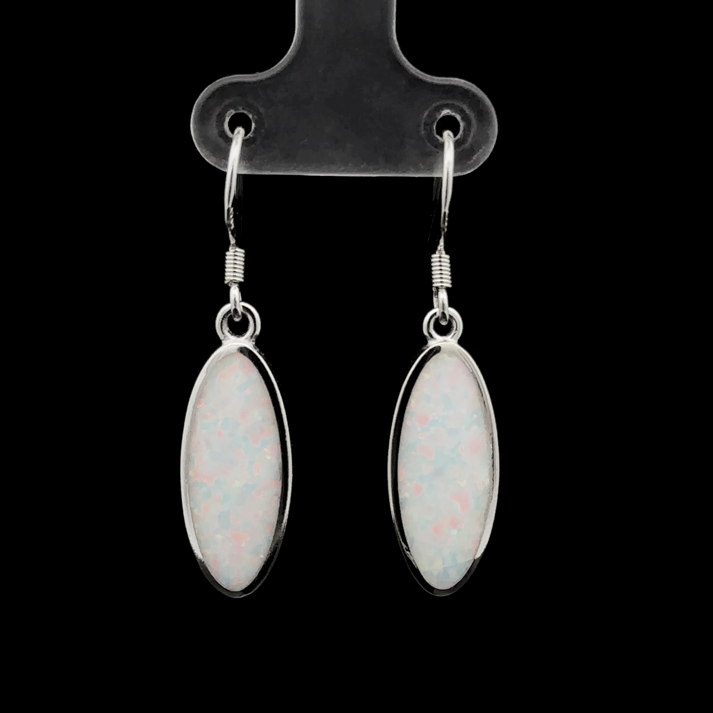 
                  
                    A pair of Simple Oval Lab-Created Opal Earrings with silver hooks displayed on a black background.
                  
                