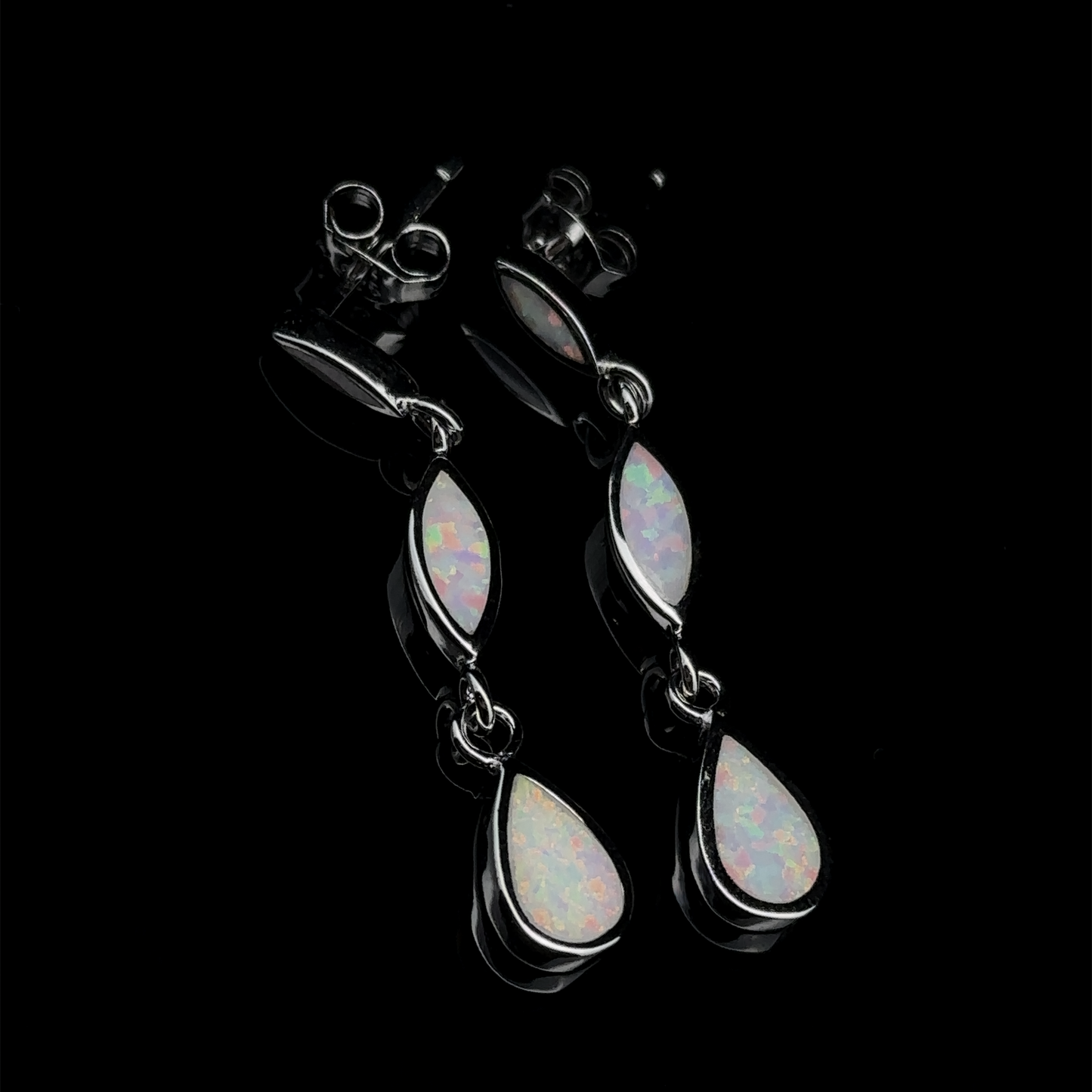 
                  
                    The Elegant Lab-Created Opal Earrings showcase sterling silver craftsmanship with marquise and teardrop-shaped lab-created opal stones set against a sleek black background.
                  
                