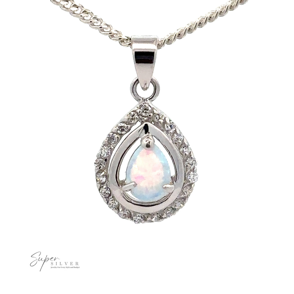 
                  
                    A teardrop-shaped Opal Pendants with Cubic Zirconia, adorned with small cubic zirconia stones on a silver chain. The design evokes Art Deco jewelry charm. The "Super Silver" logo graces the bottom-left corner.
                  
                