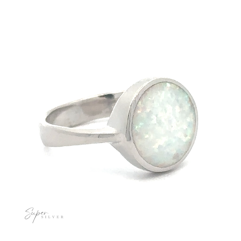 Simple Round White Opal Ring with a round, opalescent stone.