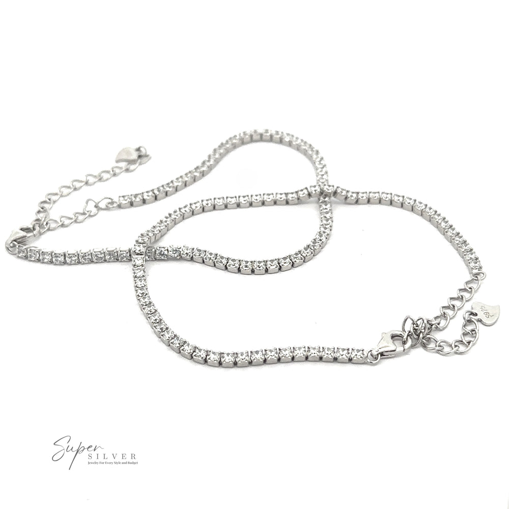 Square Cubic Zirconia Tennis Bracelet with a row of clear gemstones, adjustable chain, and heart-shaped tag on a white background.