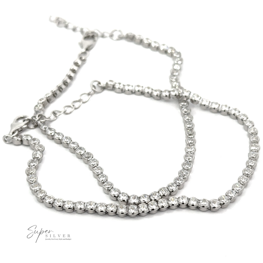 A delicate sterling silver bracelet with small, round beads set in a double strand design, featuring a lobster clasp and an adjustable chain. This elegant piece is akin to a Round Cubic Zirconia Tennis Bracelet, adding an extra touch of sparkle to your wrist.