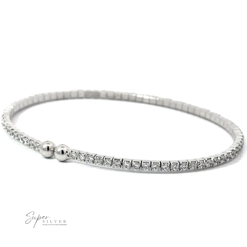 
                  
                    A Cubic Zirconia Simple Wrap Bracelet with small, round, white Cubic Zirconia stones and two silver beads near the clasp, displayed on a white background. The adjustable wrist design ensures a perfect fit. The logo "Super Silver" is in the bottom left corner.
                  
                