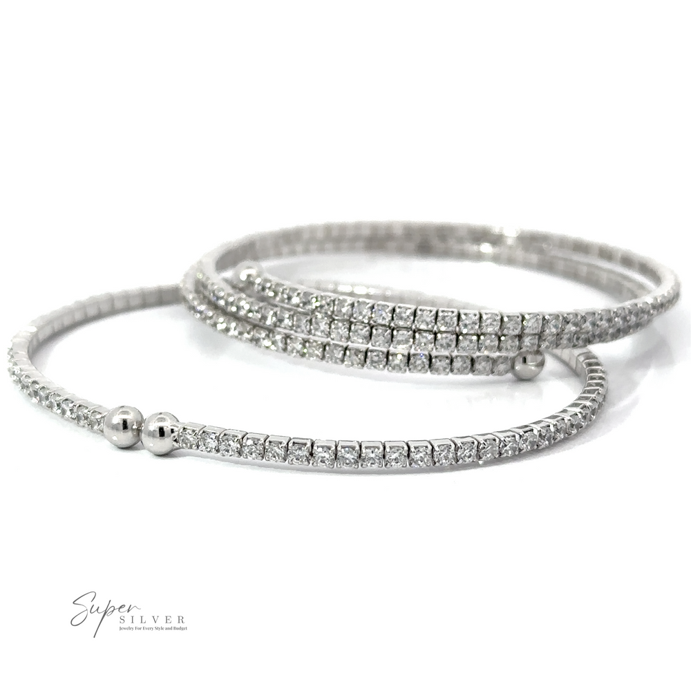 Three Cubic Zirconia Simple Wrap Bracelets, one with two beads and the other two adorned with small rhinestones and cubic zirconia, are displayed against a white background.