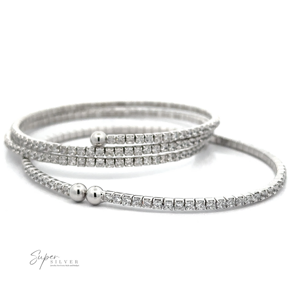 Two Cubic Zirconia Simple Wrap Bracelets encrusted with small Cubic Zirconia, each featuring a spherical clasp, are displayed against a white background. The image includes a small 