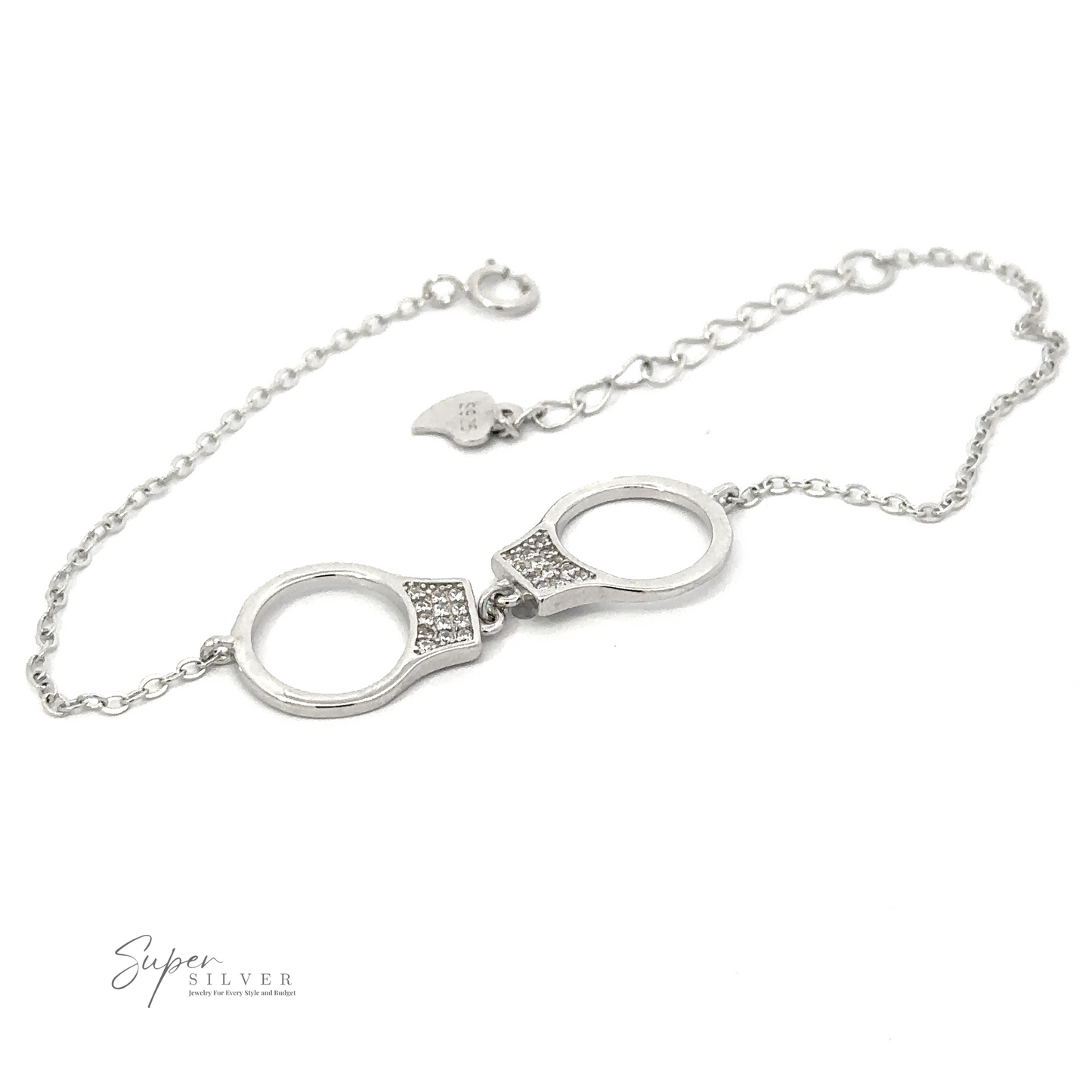 A Delicate Cubic Zirconia Handcuff Bracelet with small handcuff-shaped links and an adjustable chain, featuring the brand name "Super Silver" printed in the bottom left corner.