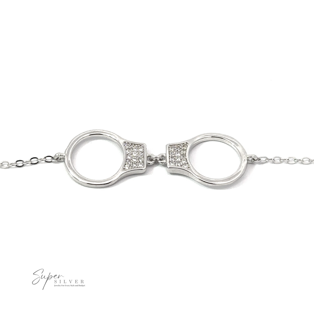 A Delicate Cubic Zirconia Handcuff Bracelet with a polished finish and small cubic zirconia stones, shown on a white background. The logo "Super Silver" appears in the bottom left corner.