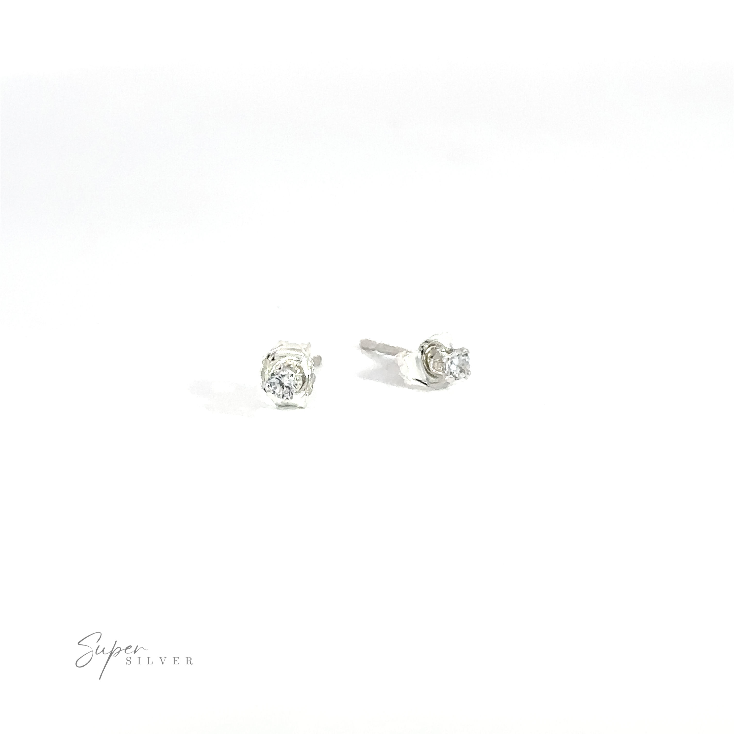A pair of versatile Round CZ Studs with round, clear cubic zirconia gemstones on a white background.