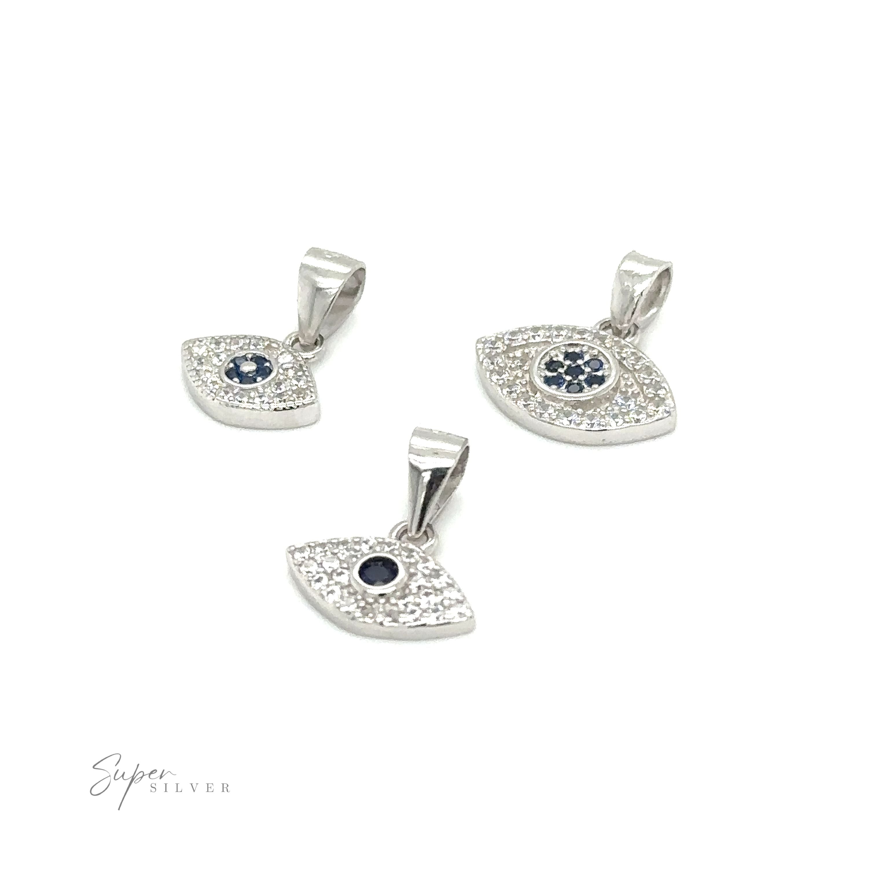 Three Evil Eye Pave Cubic Zirconia Charms adorned with diamonds and blue sapphires.