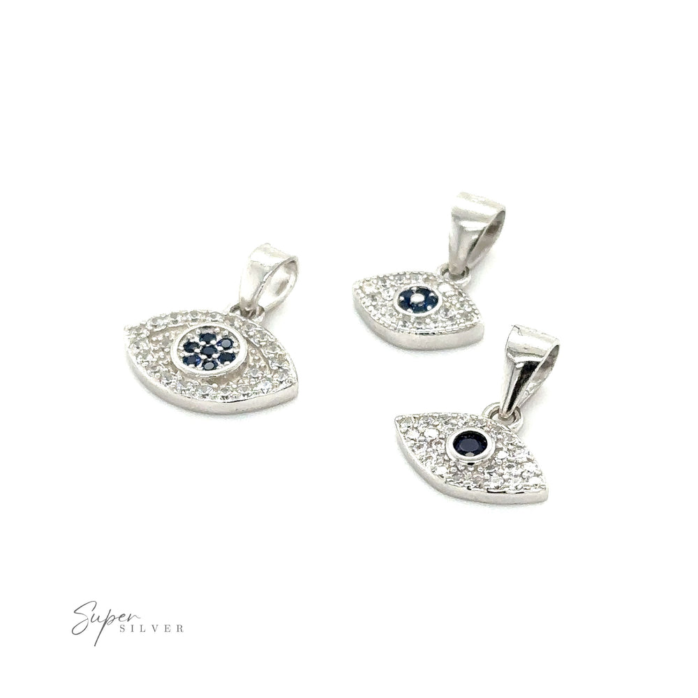 A pair of Evil Eye Pave Cubic Zirconia charm pendants adorned with blue and white diamonds.