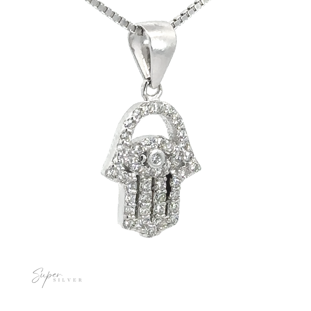 
                  
                    Close-up of a Small Cubic Zirconia Hamsa Pendant encrusted with small cubic zirconia, hanging from a rhodium plated sterling silver chain. The pendant features a hand design with fingers pointing downwards.
                  
                
