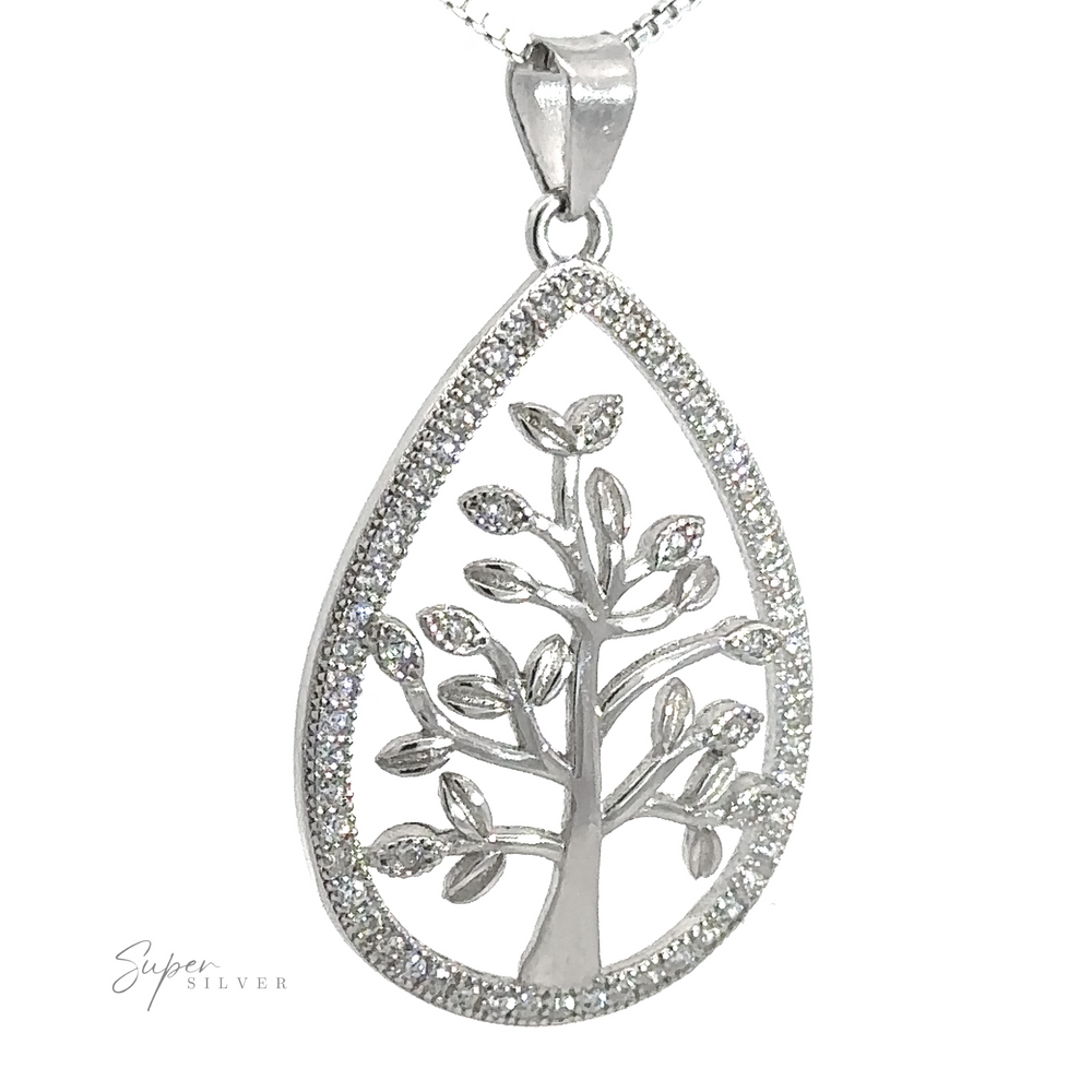 
                  
                    A teardrop-shaped sterling silver Brilliant CZ Tree of Life Pendant featuring an intricate tree design with small leaves, framed by a border of sparkling cubic zirconia stones, hangs from a delicate chain.
                  
                