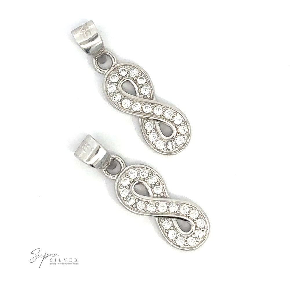 Two Cubic Zirconia Infinity Pendants encrusted with small round crystals on a white background. The "Super Silver" logo is visible in the bottom left corner.