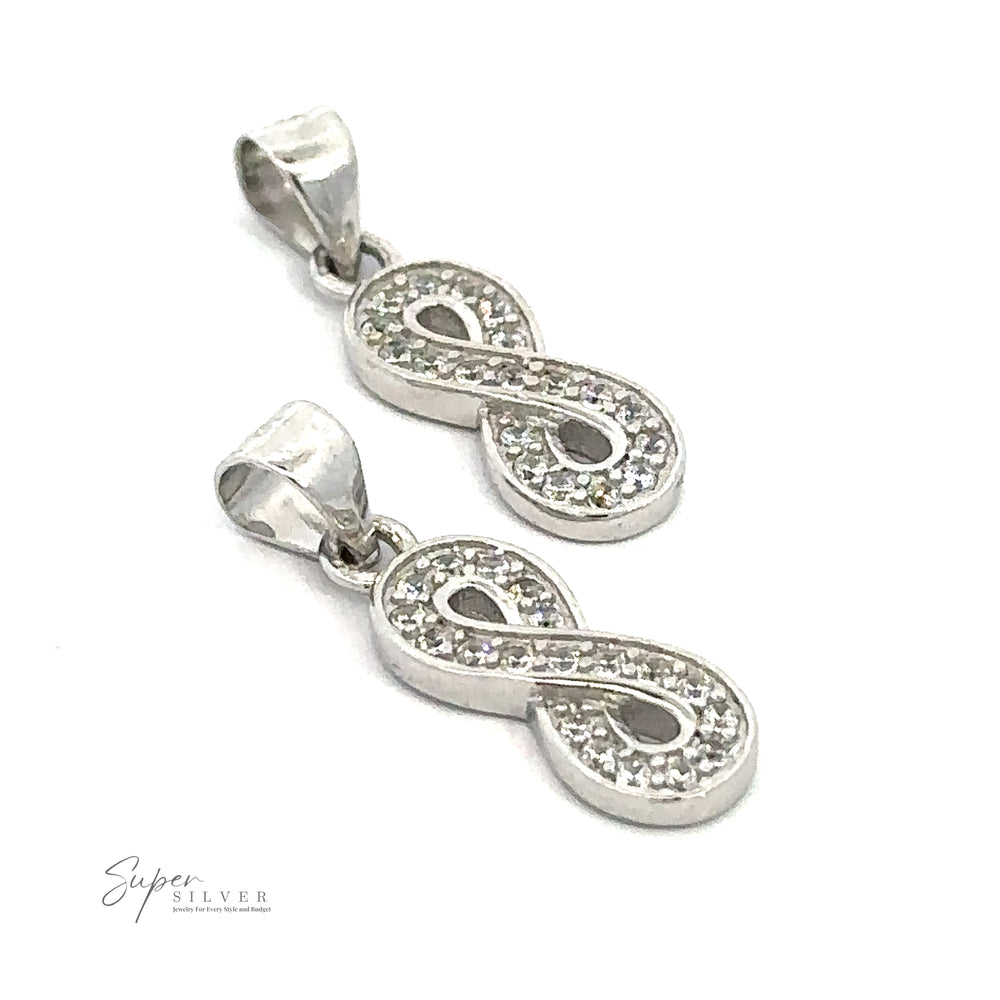 
                  
                    Two infinity-shaped sterling silver pendants with embedded small, sparkly stones are elegantly displayed on a white background. The gleaming Cubic Zirconia Infinity Pendant adds a touch of luxury, while the "Super Silver" logo is visible in the lower left corner.
                  
                