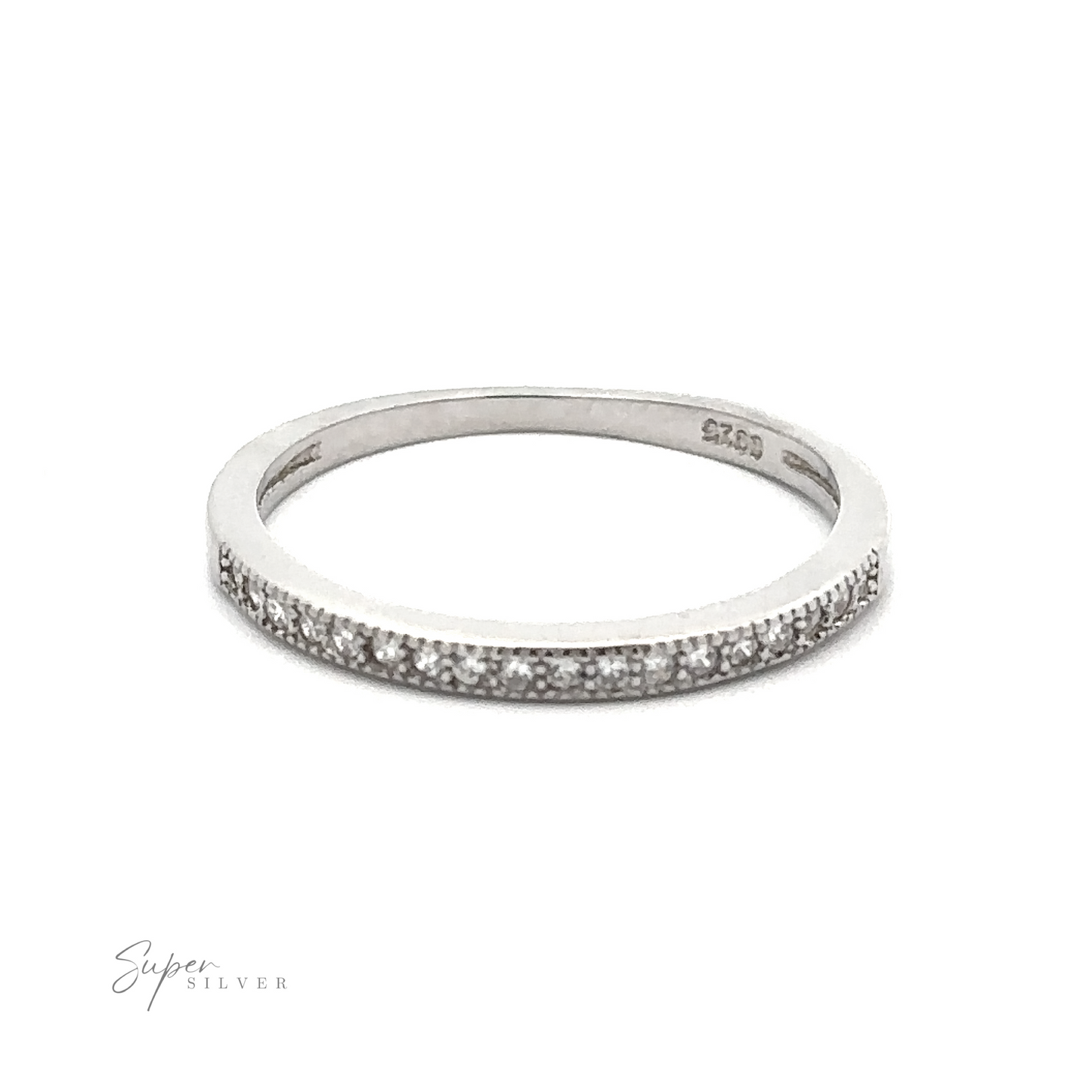 
                  
                    A thin silver ring with small embedded cubic zirconia, photographed on a plain white background. Engraving on the inner side reads ".925 Sterling Silver." The lower left corner displays the text "Classic Pave Cubic Zirconia Eternity Ring.
                  
                