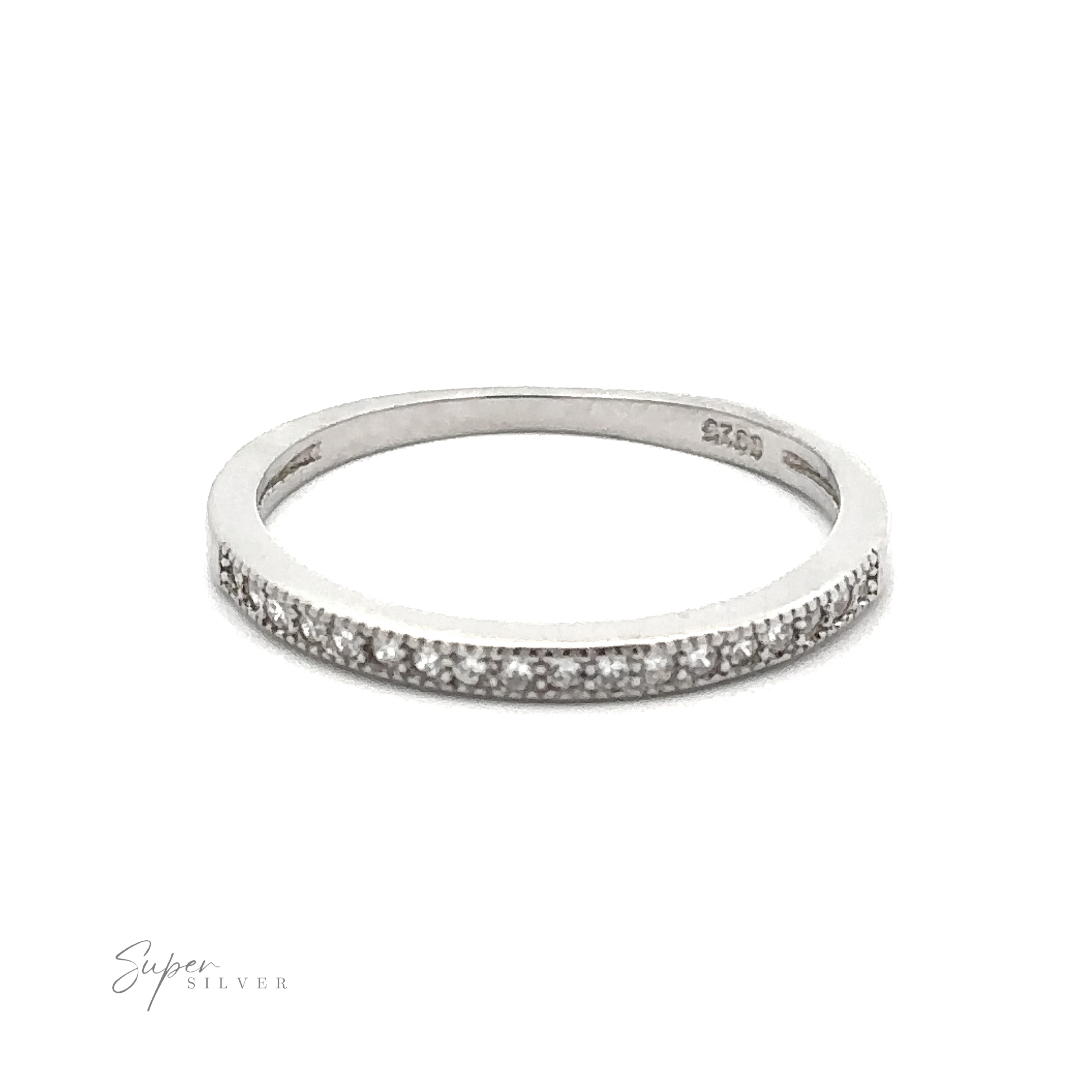 A thin silver ring with small embedded cubic zirconia, photographed on a plain white background. Engraving on the inner side reads ".925 Sterling Silver." The lower left corner displays the text "Classic Pave Cubic Zirconia Eternity Ring.