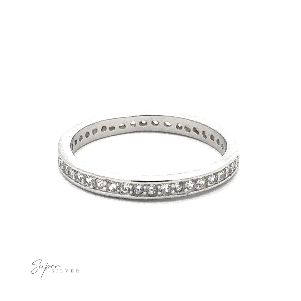 
                  
                    A *Classic Pave Cubic Zirconia Eternity Ring* crafted from .925 Sterling Silver, adorned with small, round cubic zirconia stones around its circumference, is positioned against a white background. The words "Super Silver" are written in the bottom left corner.
                  
                