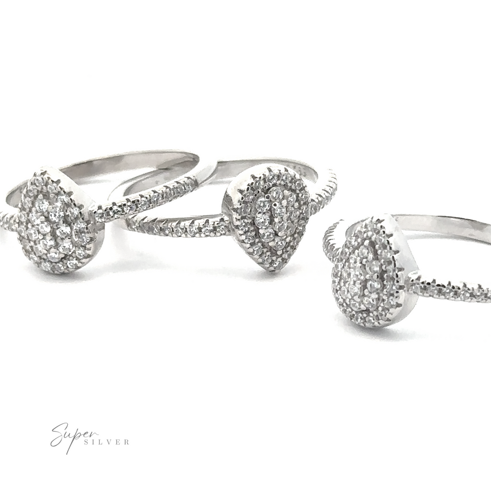 Three Teardrop Pave Cubic Zirconia Rings, crafted in sterling silver with a rhodium finish, are displayed against a white background. Text in the bottom left reads "Super Silver.